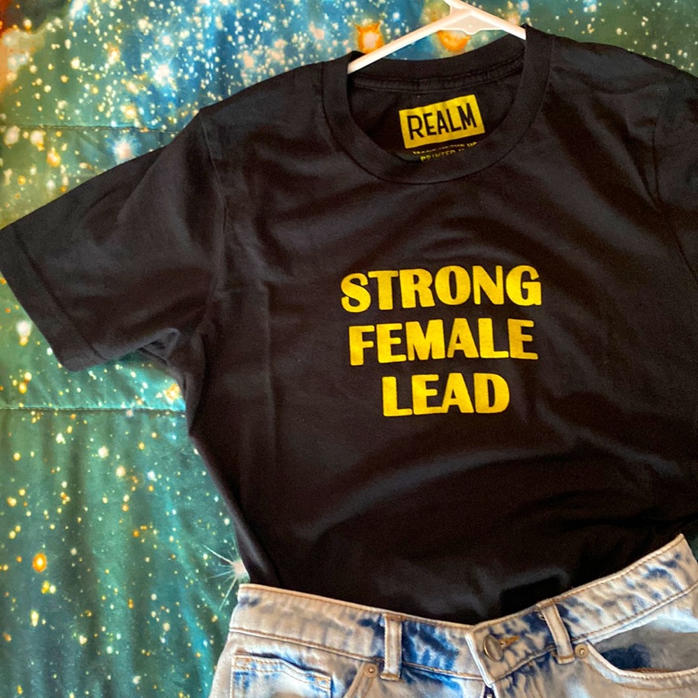 🖤💛 STRONG FEMALE LEAD TEE - Realm Tshirt